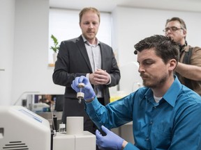 Jeff Smith (left), director of the mass spectrometry centre at Carleton University, and Karl Wasslen, operations manager of Carleton‚Äôs mass spectrometer lab demonstrate a fentanyl testing device in Ottawa, Thursday, May 3, 2018.