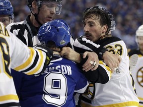 Boston Bruins left wing Brad Marchand (63) and Tampa Bay Lightning centre Tyler Johnson (9) scrap during the first period of Game 2 of an NHL second-round hockey playoff series Monday, April 30, 2018, in Tampa, Fla. Boston Bruins forward Brad Marchand has received a warning from the NHL about licking the faces of his opponents.