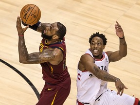 LeBron James of the Cleveland Cavaliers attempts a shot past the Raptors' DeMar DeRozan during Game 1 of their Eastern Conference semifinal series at Toronto's Air Canada Centre on Tuesday night.