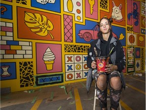 Artist Victoria Sieczka puts the finishing touches to her mural under the Granville Street Bridge in the new Chain & Forge public area.