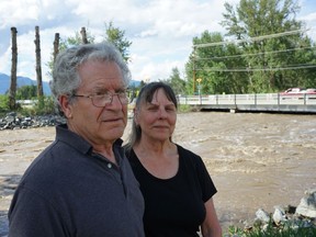 Eugene and Barb Filice stand on the bank of Mission Creek near Spiers Road, a short walk from their home.