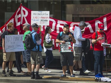 Protesters gathered outside the TD Bank tower at Georgia and Howe Streets in Vancouver to protest against TD and other banks financing the Kinder Morgan pipeline.