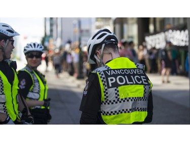 Vancouver Police officers were on hand to ensure crowd control as protesters gathered outside the TD Bank tower at Georgia and Howe Streets to protest against TD and other banks financing the Kinder Morgan pipeline.