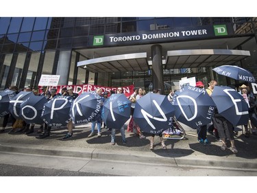 Protesters gathered outside the TD Bank tower at Georgia and Howe Streets in Vancouver to protest against TD and other banks financing the Kinder Morgan pipeline.