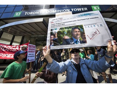 Protesters gathered outside the TD Bank tower at Georgia and Howe Streets in Vancouver to protest against TD and other banks financing the Kinder Morgan pipeline.