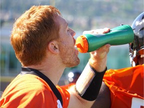 Travis Lulay, who is coming off of knee surgery, takes a sip of water at B.C. Lions training camp in Kamloops.