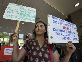 Protesters gather inside Richmond City Hall on Monday night against Richmond council's decision to continue to allow almost-11,000-sq.-ft homes on ALR property. Here, protester Niti Sharma vents her frustration.