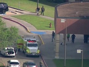 In this image taken from video law enforcement officers respond to a high school near Houston after an active shooter was reported on campus, Friday, May 18, 2018, in Santa Fe, Texas.