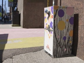 A newspaper box re-purposed by SFU art students in downtown Vancouver to serve as a "Free Little Library."