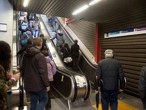 Passengers on escalators at downtown Vancouver SeaBus terminal on May 4, 2018.