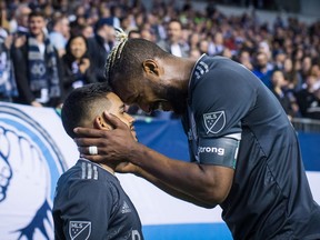 Marcel de Jong of the Vancouver Whitecaps joked Tuesday that his team might consider putting Cristian Techera, left, on someone's shoulders when Kendall Waston, right, leaves for the World Cup in Russia later this month.