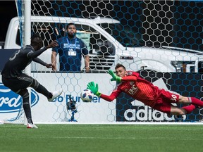 New England Revolution goalkeeper Matt Turner dives to make a huge save off Kei Kamara of the Whitecaps during Saturday's MLS action at B.C. Place Stadium in Vancouver.