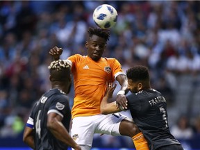 Alberth Elis of the Houston Dynamo heads the ball above Sean Franklin of the Vancouver Whitecaps. The visitors nearly came out on top until Kendall Waston's injury-time header earned Vancouver a draw.