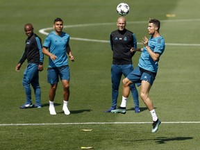 Real Madrid's Cristiano Ronaldo, right, heads the ball during a training session in Madrid on Tuesday. Real Madrid will play the Champions League final match against Liverpool on Saturday.