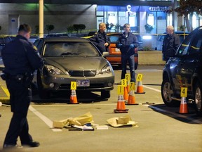 Police cordon off the scene at Burnaby’s Metrotown mall on the night of Oct. 16, 2010, where Gurmit Dhak was murdered, igniting a gang war with seemingly no end. Nearly eight years later, no one has been charged. (Photo: Ric Ernst, PNG files)