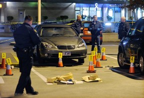 Police cordon off the scene at Burnaby’s Metrotown mall on the night of Oct. 16, 2010, where Gurmit Dhak was murdered, igniting a gang war with seemingly no end. Nearly eight years later, no one has been charged. (Photo: Ric Ernst, PNG files)