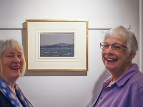 Marit Mayne (left) and Glenna Gardiner pose with the Tom Thomson painting Sketch of a Lake at the Heffel Gallery in Vancouver. The painting sold for $481,250 at a Heffel auction May 30, and Gardiner will be taking Mayne and her husband on a Mediterranean cruise. Ward Bastian/Heffel Art Auction House.