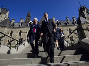 Natural Resources Minister James Carr and Finance Minister Bill Morneau leave a cabinet meeting on route to the National Press Theatre in Ottawa on Tuesday, May 29, 2018. Finance Minister Bill Morneau says Canada is going to buy the Trans Mountain pipeline and all of Kinder Morgan Canada's core assets for $4.5 billion.