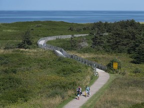 Visitors walk on the boardwalk on the Greenwich peninsula portion of Prince Edward Island National Park in Greenwich, Prince Edward Island in August 2017.