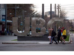 People walk past large letters spelling out UBC at the University of B.C. in Vancouver on Nov. 22, 2015.