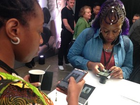 People try out the new BlackBerry KEY2 phone at a launch event in New York City on Thursday, June 7, 2018.