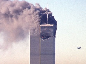 This file photo taken on Sept. 11, 2001, shows a hijacked commercial plane approaching the World Trade Center shortly before crashing into the landmark skyscraper in New York.   The Twin Towers collapsed later that day.