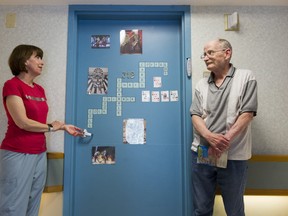 Evelyn Sanduleak and Dennise Keefe outside his personalized painted door to his room at the Youville Residence in Vancouver.