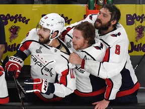 Chandler Stephenson, Nicklas Backstrom and Alex Ovechkin of the Washington Capitals watch the final seconds of Game Five of the 2018 NHL Stanley Cup Final tick off the clock as they wait to jump the boards to celebrate their 4-3 win over the Vegas Golden Knights at T-Mobile Arena on June 7, 2018 in Las Vegas, Nevada.