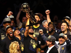 Stephen Curry of the Golden State Warriors celebrates with the Larry O'Brien Trophy after defeating the Cleveland Cavaliers during Game Four of the 2018 NBA Finals at Quicken Loans Arena on June 8, 2018 in Cleveland, Ohio. The Warriors defeated the Cavaliers 108-85 to win the 2018 NBA Finals.