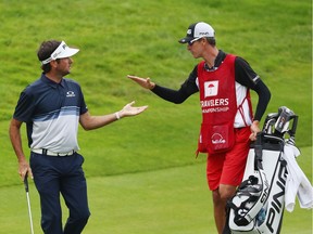 Bubba Watson of the United States celebrates with caddie Ted Scott on the 18th hole during the final round of the Travelers Championship at TPC River Highlands on June 24, 2018 in Cromwell, Connecticut.