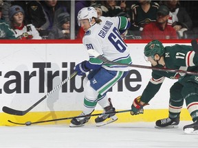 ST. PAUL, MN - JANUARY 14: Markus Granlund #60 of the Vancouver Canucks skates with the puck against Marcus Foligno #17 of the Minnesota Wild during the game at the Xcel Energy Center on January 14, 2018 in St. Paul, Minnesota. (Photo by Bruce Kluckhohn/NHLI via Getty Images) ORG XMIT: 775041205 Not Released