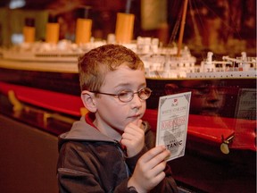 Boy with replica boarding pass from Titanic: The Artifact Exhibition by Premier Exhibitions at Lipont Place, Richmond, June 23, 2018 to Jan. 11, 2019.  [PNG Merlin Archive]