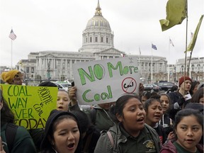 In this Feb. 28, 2018, file photo, students rally for clean energy in front of San Francisco City Hall. A U.S. judge who held a hearing about climate change that received widespread attention has thrown out the underlying lawsuits that sought to hold big oil companies liable for the role of fossil fuels in the Earth's warming environment. Judge William Alsup in San Francisco said Monday, June 25, 2018, that Congress and the president, not a federal judge, were best suited to address fossil fuels' contribution to global warming.