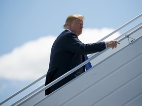 President Donald Trump boards Air Force One for a trip to Singapore to meet with North Korean leader Kim Jong Un, Saturday, June 9, 2018, at Canadian Forces Base Bagotville, in Canada.