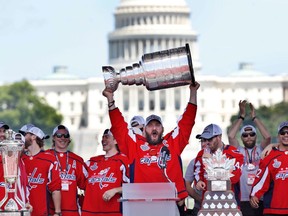 Washington Capitals' Alex Ovechkin holds up the Stanley Cup trophy during the NHL hockey team's victory celebration on June 12, 2018