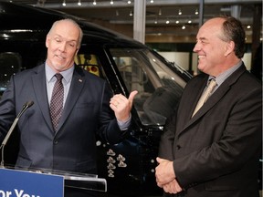 Premier John Horgan and Green leader Andrew Weaver hold a press conference to celebrate the one-year anniversary of their confidence and supply power-sharing agreement at the Alacrity Foundation in downtown Victoria on May 29, 2018. [PNG Merlin Archive]