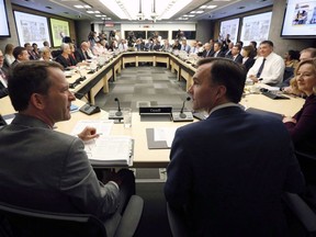 Federal Finance Minister Bill Morneau, centre, along with his Deputy Minister Paul Rochon, left, and Deputy Governor of the Bank of Canada Carolyn Wilkins, right, as they prepare to meet with provincial and territorial finance ministers in Ottawa, Monday June 19, 2017. Canada's long-simmering internal debate over the how the federal government divvies up equalization payments among the provinces is expected to flare up this week during the twice-yearly gathering of the country's finance ministers.