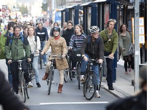 Copenhagen residents have five times more bikes than cars. According to studies, bicycling makes people feel better. Polls show Danes are all right with paying high taxes for infrastructure and support services. (Photo: A bike lane during rush hour in Copenhagen.)