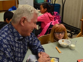 Principal Angelo Morelli of Ecole K.B. Woodward in Surrey with children in his school's breakfast program aided by The Sun's Adopt-a-School campaign.