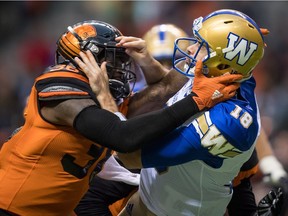 Dyshawn Davis of the B.C. Lions gets his paws on Winnipeg Blue Bombers' quarterback Alex Ross during Friday's CFL pre-season action at B.C. Place Stadium in Vancouver. The Lions are determined to improve their product on and off the field this season.