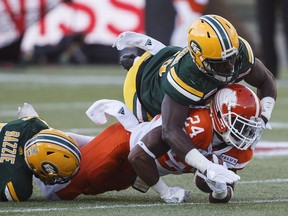 Jeremiah Johnson of the B.C. Lions is pounded into the ground by Christophe Mulumba-Tshimanga of the Edmonton Eskimos during Friday's CFL action at Commonwealth Stadium in Edmonton. The Lions led 14-2 in the second quarter, but the Eskimos took over after that and beat the visitors 41-22.