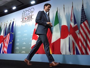 Canada's Prime Minister Justin Trudeau walks off the stage after speaking at a press conference at the G7 leaders summit in La Malbaie, Que., on Saturday, June 9, 2018.