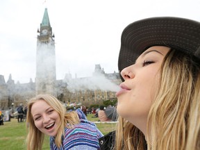 Two women smoke weed on Parliament Hill on 4/20 in Ottawa, Ontario, April 20, 2017.