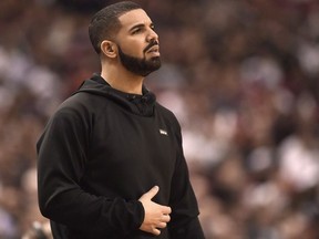 Rapper Drake watches the action between the Indiana Pacers and the Toronto Raptors during first half NBA playoff basketball action in Toronto on Tuesday, April 26, 2016. Drake is making history on the Billboard charts again with his song "God's Plan."