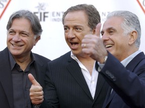 FILE - In this May 9, 2002 file photo, Guess Inc. founders and brothers, from left, Armand, Paul and Maurice Marciano arrive at the company's 20th anniversary party in Los Angeles. Guess Inc. says its co-founder Paul Marciano is stepping down after a company-commissioned investigation of allegations of sexual harassment and assault. The company announced in a filing Tuesday, June 12, 2018, with the Securities and Exchange Commission that Marciano is resigning immediately as executive chairman of the Guess board, and his brother and co-founder Maurice Marciano will take over.