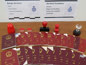 Chinese passports and stamps seized by CBSA as part of an investigation into an immigration fraud scheme run by Xun Wang in Metro Vancouver.