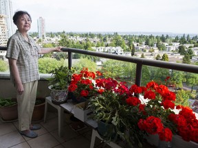 Tina Gully on the balcony of the Metrotown-area apartment she has lived in for 25 years, and is now at the heart of a property dispute with the company Ledcor Construction Ltd.