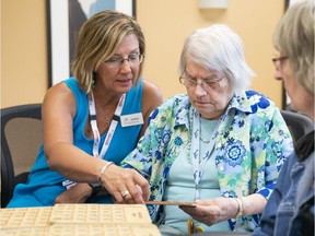 Karen Baillie, CEO of Menno Place, plays bingo with Anne Braun at the Abbotsford facility. Menno Place is a seniors care complex with multiple levels of care.