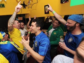 Brazilian fans celebrate their team's 2-0 win over Serbia during group-stage World Cup action at Boteco Brasil in Vancouver on June 27.