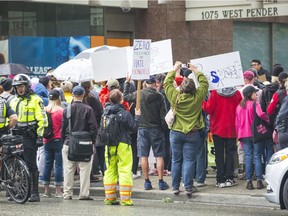 VANCOUVER, BC, Residents of Vancouver who oppose the Trump administration's "zero tolerance" policy on illegal border crossings protest outside the U.S. consulate in Vancouver.
